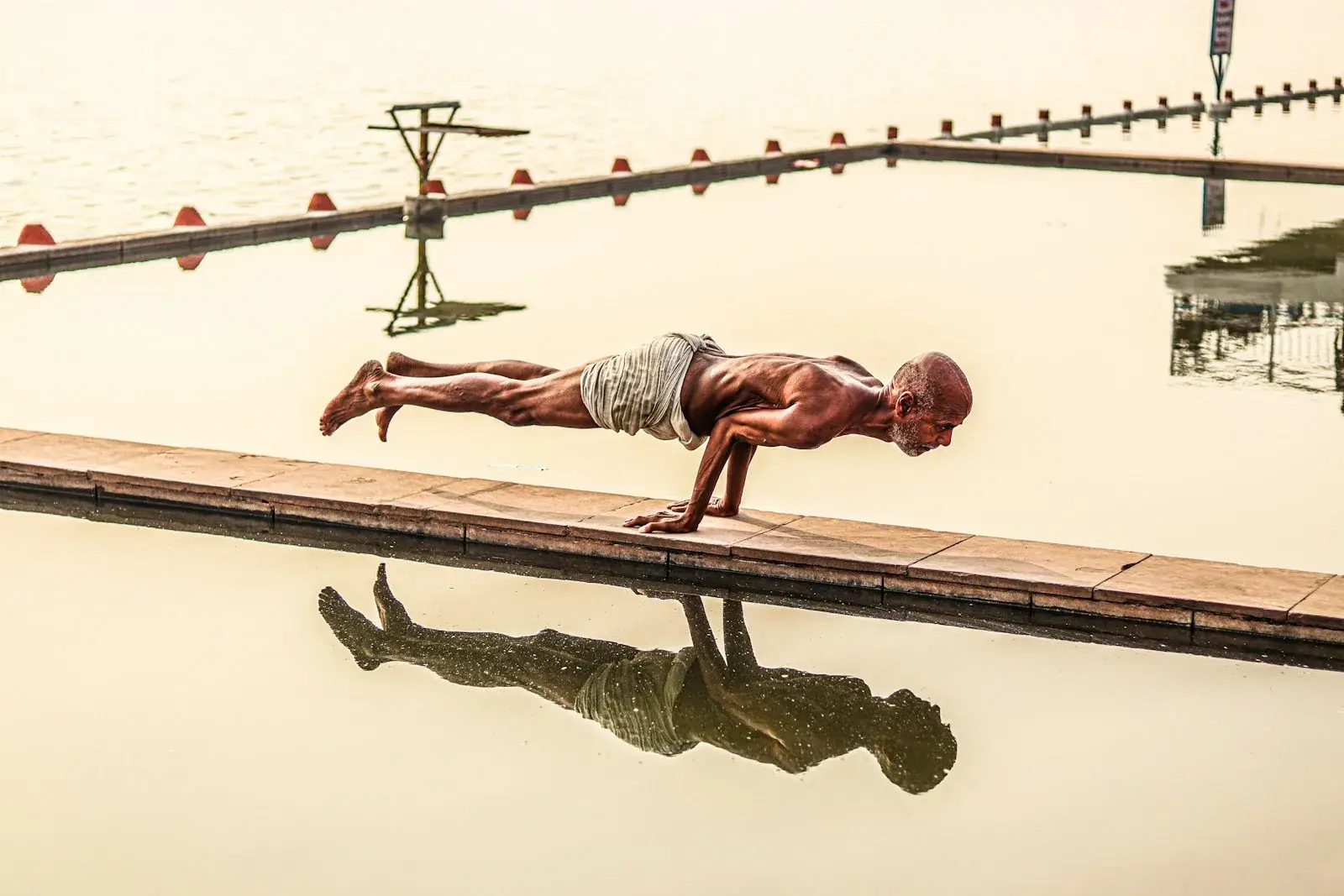 a man standing next to a body of water